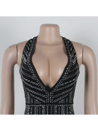 Mono con espalda descubierta, encaje y cuello halter adornado