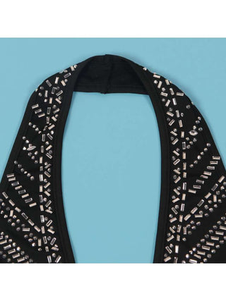 Mono con espalda descubierta, encaje y cuello halter adornado